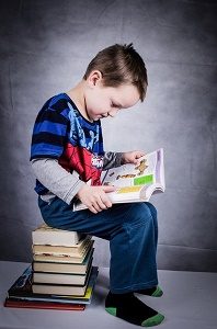 jongetje leest in boek