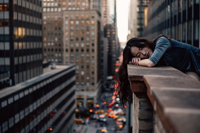 woman hanging over balcony